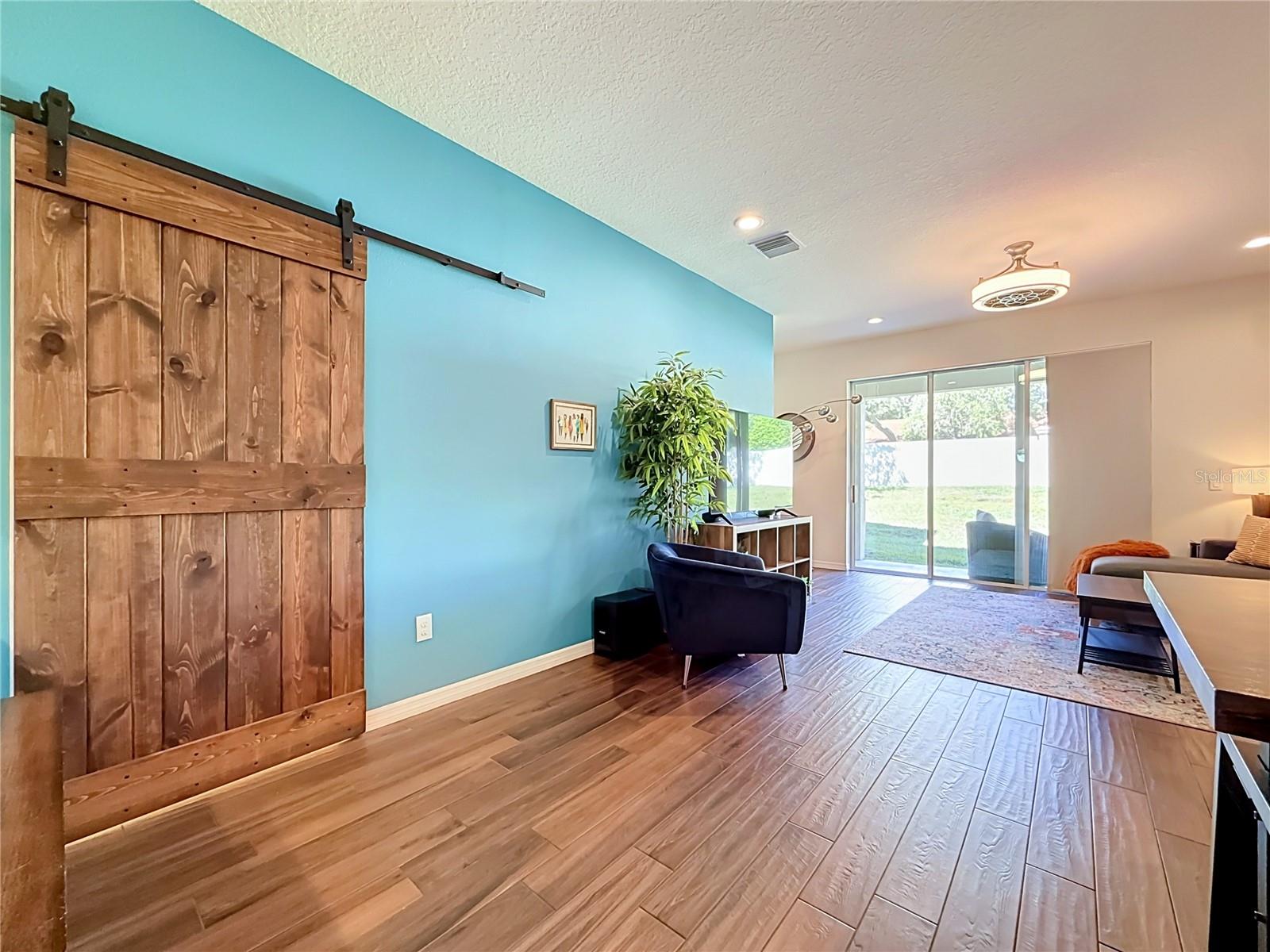 Custom wood barn door adds character to the downstairs half bath