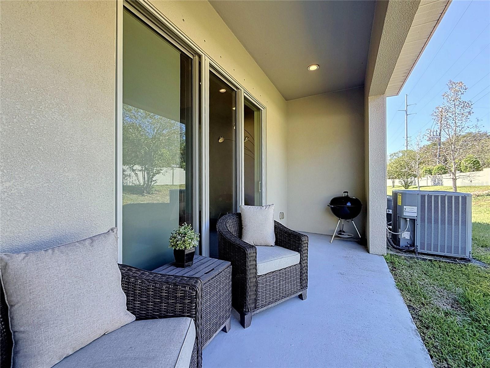 Sliding glass doors open to a PRIVATE BACK PATIO with NO REAR NEIGHBORS