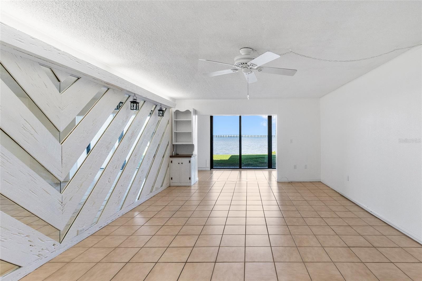 Living room looking directly towards sunroom and water view.