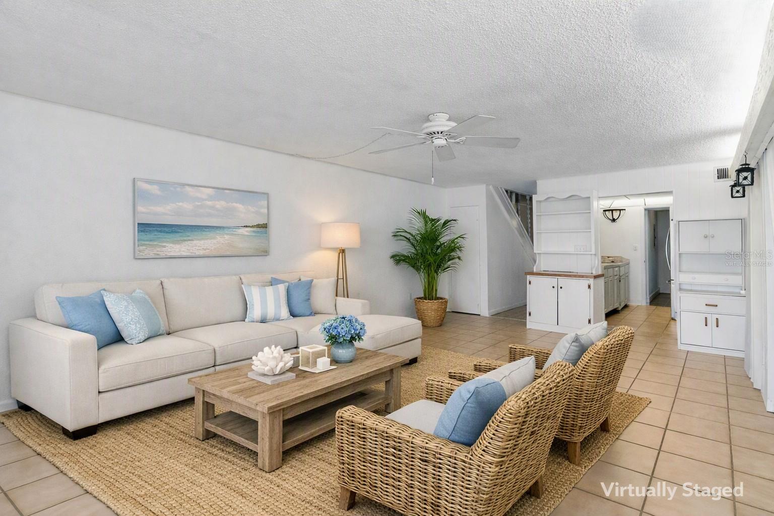Virtually staged living area looking toward kitchen