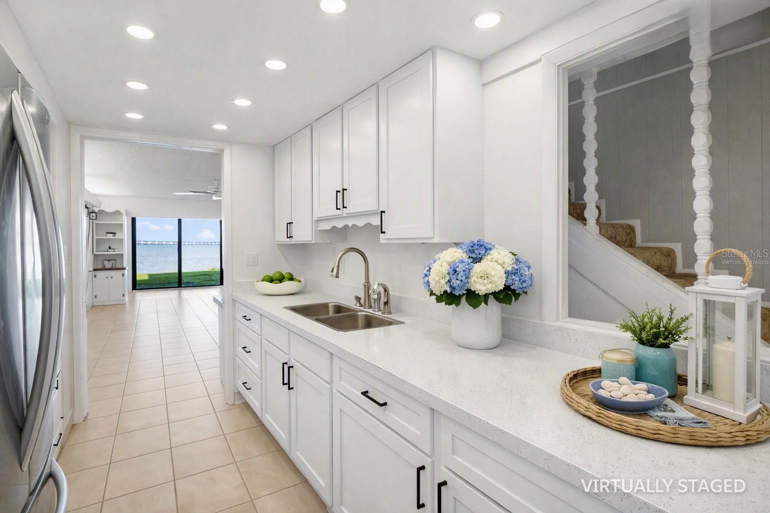 Virtually staged kitchem -to help envision recessed lighting, quart counter tops and white cabinets