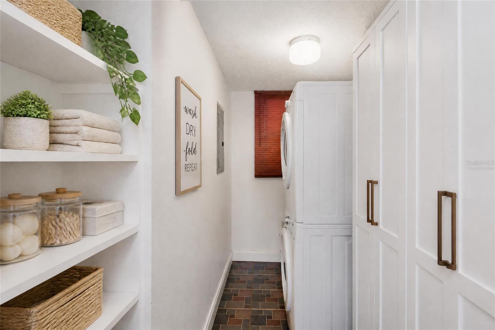 Virtually Staged - Laundry room - shelved added and HVAC enclosed in cabinets.