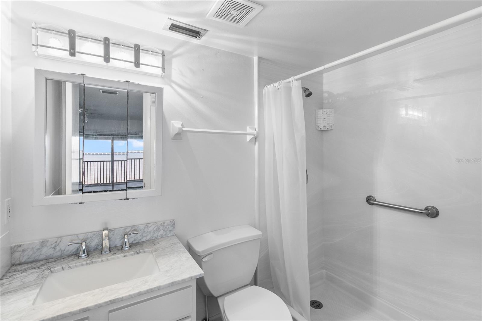 Primary bath with step in shower - water view seen in mirror