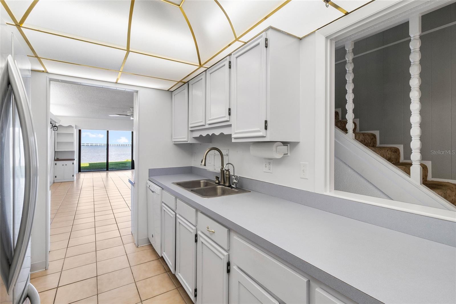 Kitchen other side looking toward living area and water view