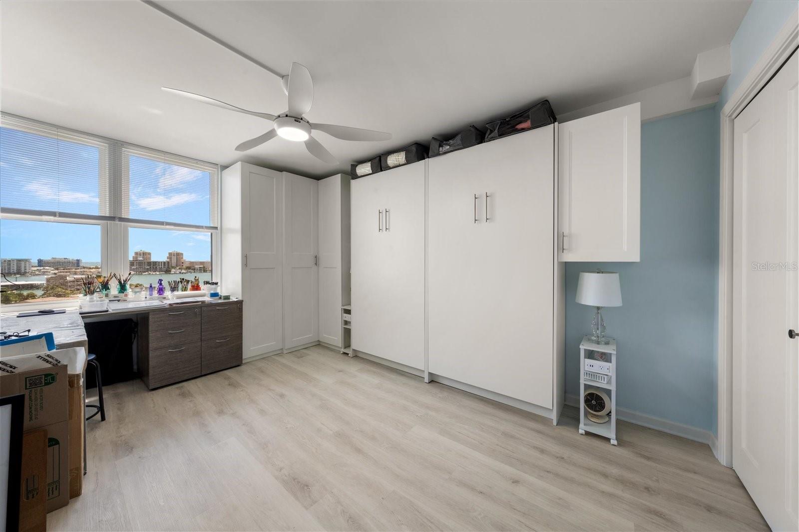 Guest bedroom featuring build in Murphy bed. Efficient option to maximize this room for additional flex space.
