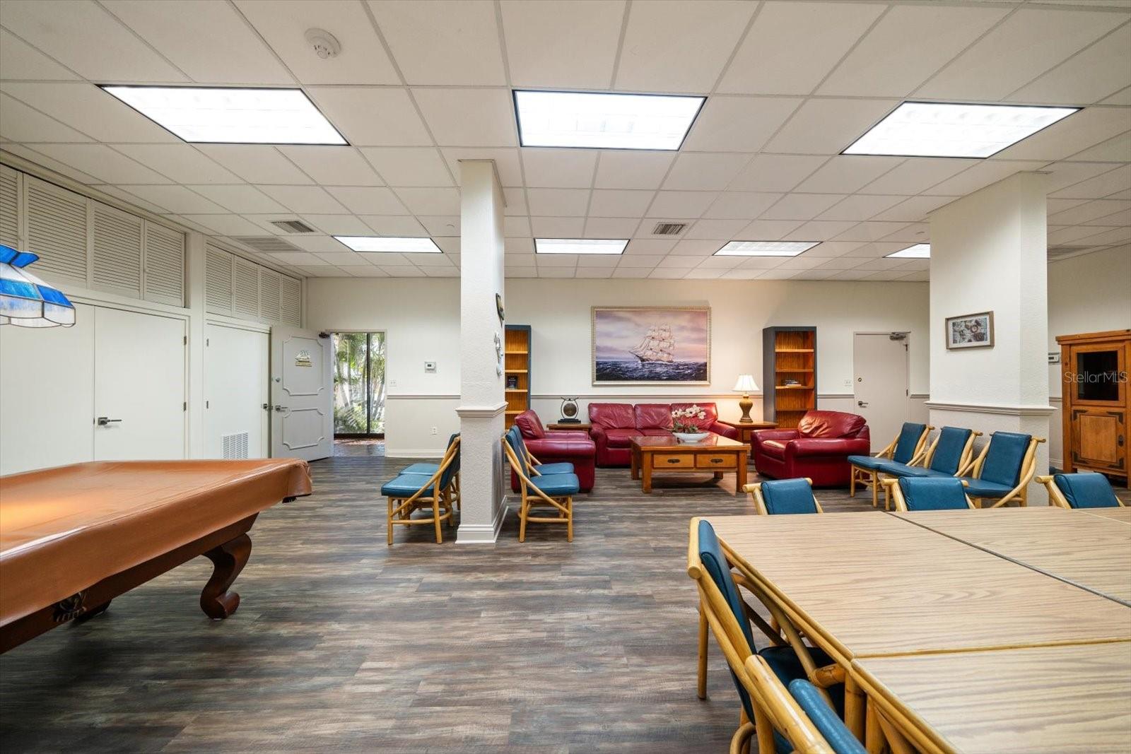Community room featuring a kitchen, gathering space & billards.