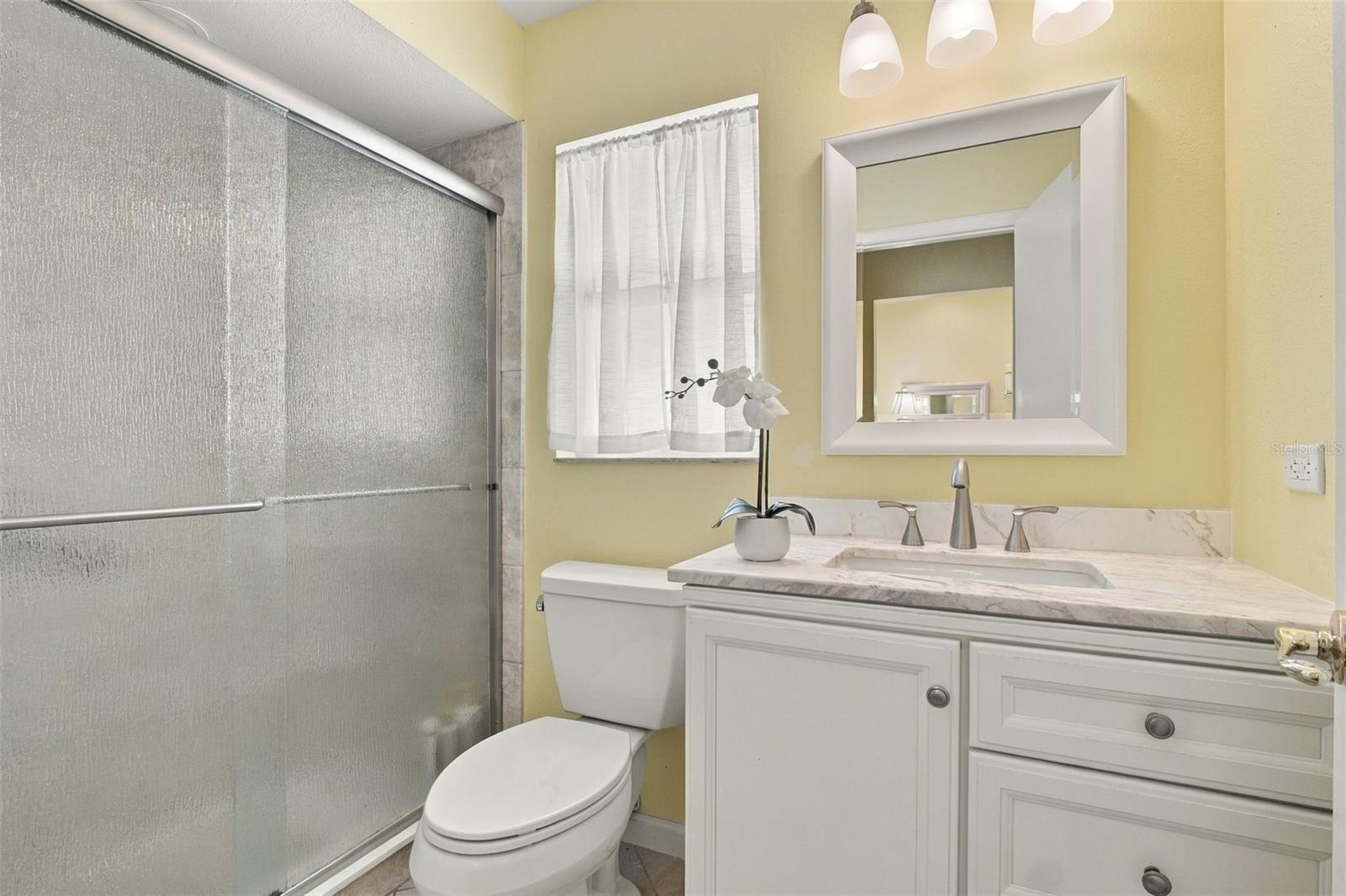 New vanity with stone top & beautiful glass enclosed walk-in shower~