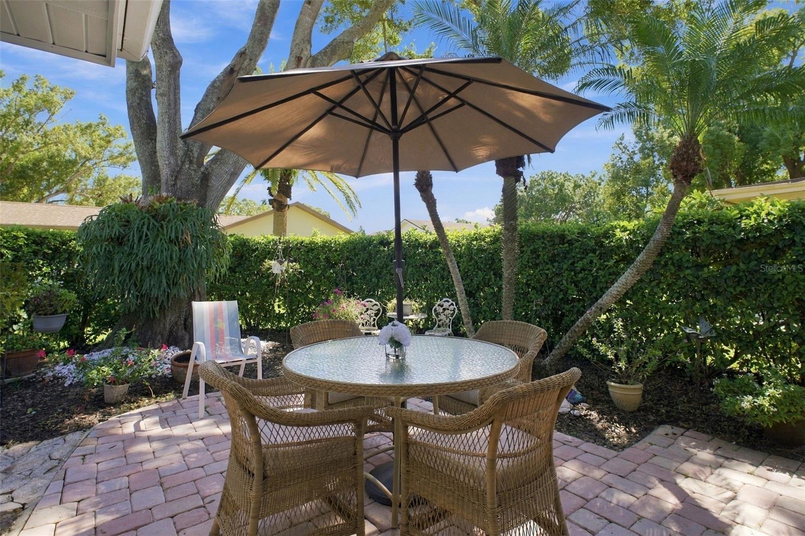 Beautiful paver patio surrounded by lush landscaping for privacy~