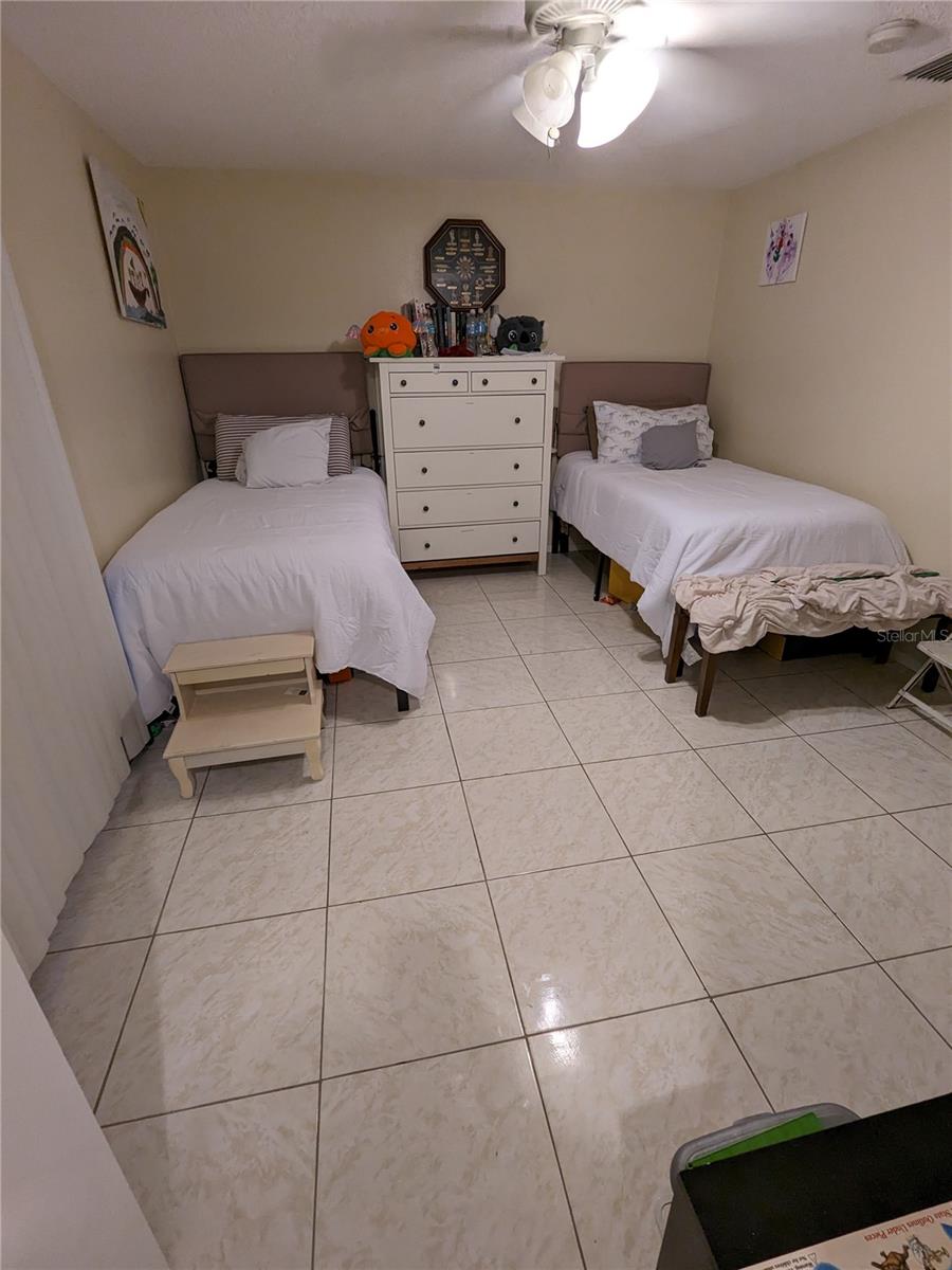 GUEST BEDROOM AT FRONT OF HOUSE HAS LONG WINDOWS & WALK-IN CLOSET