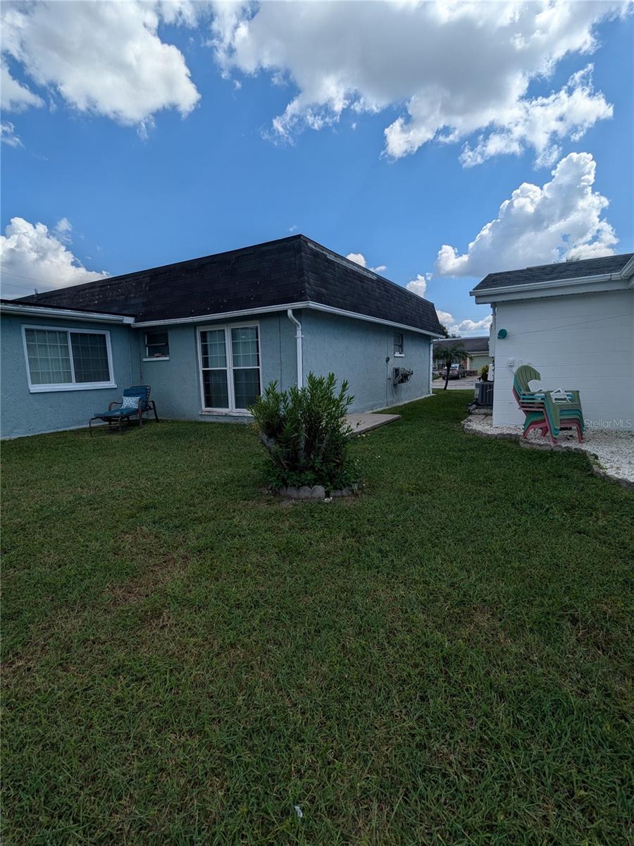 LEFT YARD AND REAR OF HOUSE