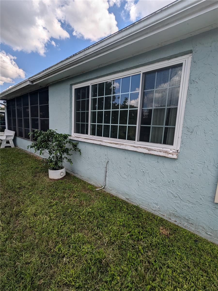 WINDOWS FROM EXTENDED LIVING AREA IN FOREGROUND AND SCREENED AND VINYL WINDOWED LANAI IN BACKGROUND