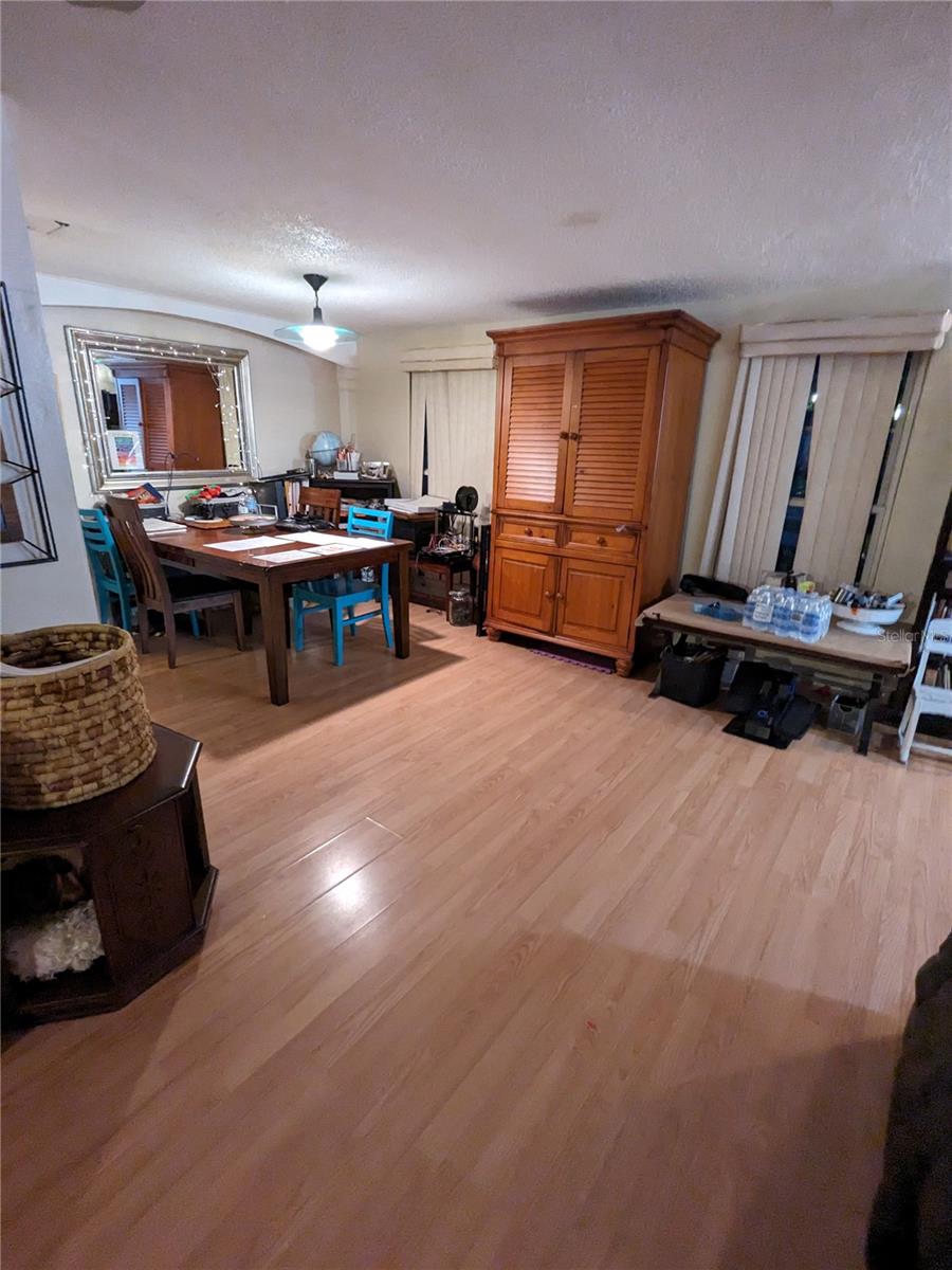 VIEW FROM LIVING ROOM TO "L" DINING ROOM AND FRONT WINDOWS