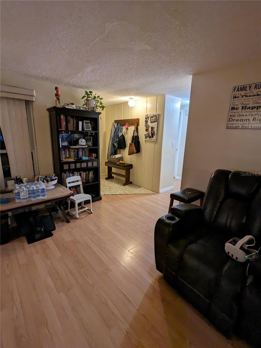 LIVING ROOM FOREGROUND AND FOYER IN BACKGROUND