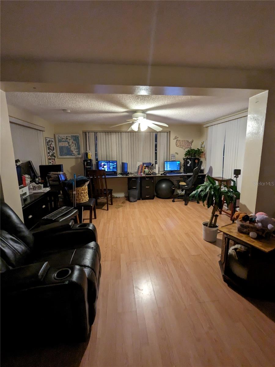 VIEW FROM LIVING ROOM TO EXTENSION OF OFFICE AND SLIDERS TO LANAI ON RIGHT