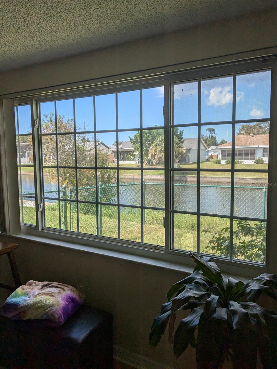 FABULOUS VIEW OF BACKYARD & FENCE WITH CANAL IN BACKGROUND
