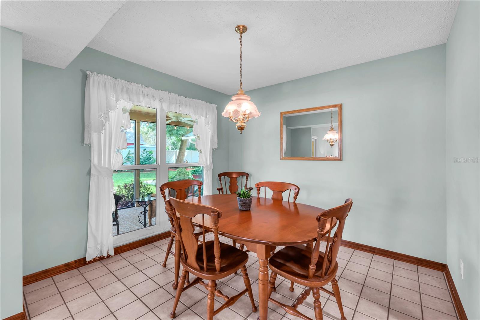 A casual dinette just off the kitchen offers a lovely view of the park-like backyard setting.
