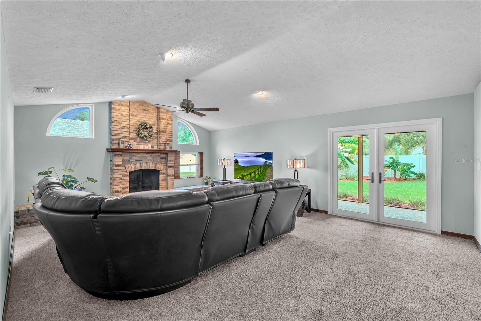 A welcoming family room with a wood burning fireplace provides the perfect setting to relax and unwind.