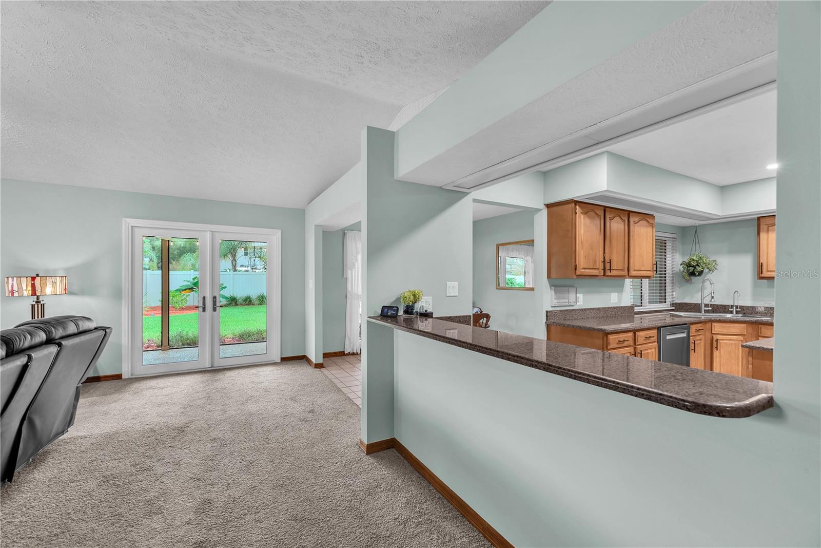 A spacious breakfast bar separates the kitchen from the family room, making it ideal for serving appetizers while entertaining family and friends.