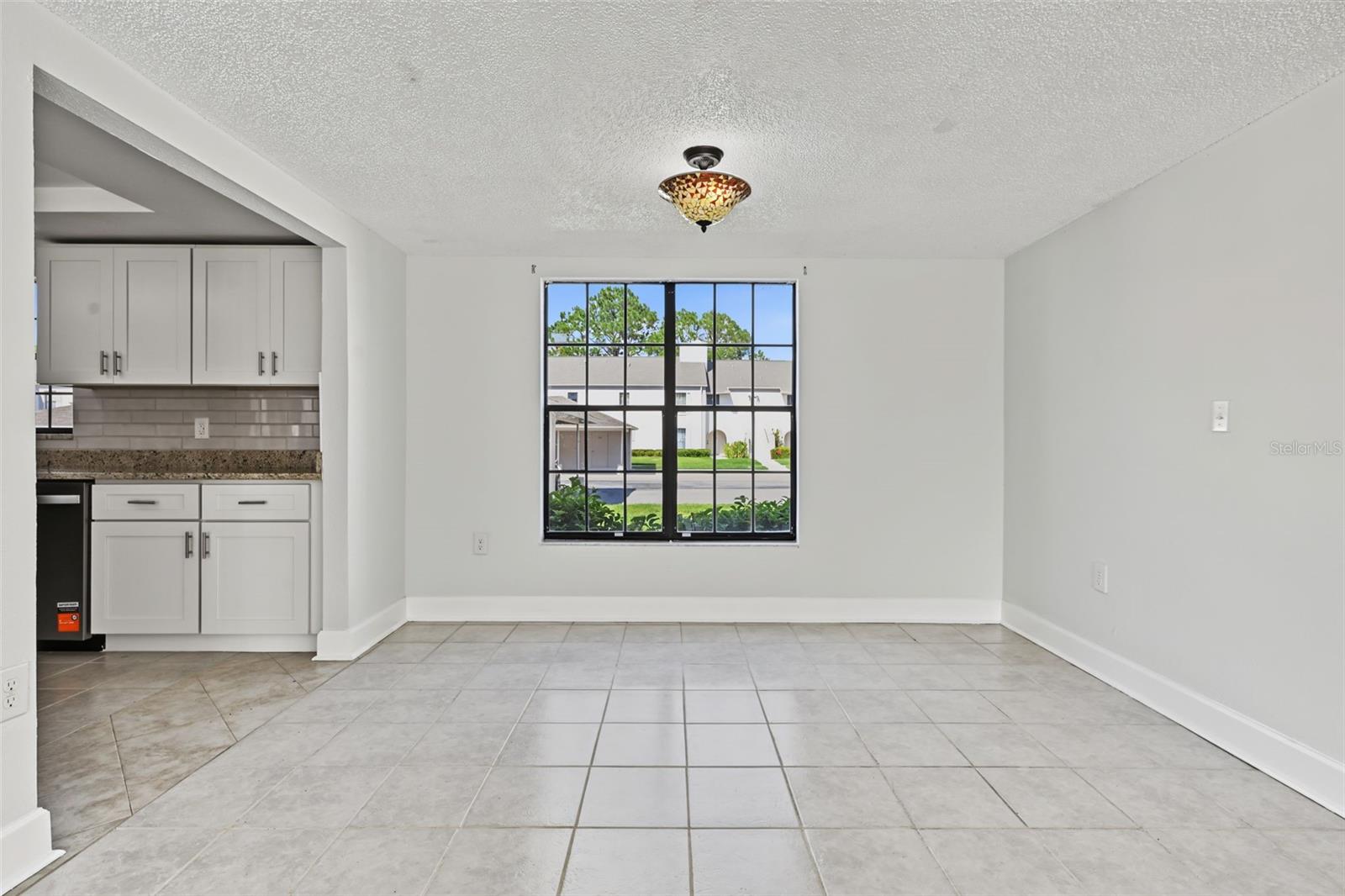 The Dining Area is just off the Kitchen and overlooks the Living Room.  The windows truly provide significant natural light.