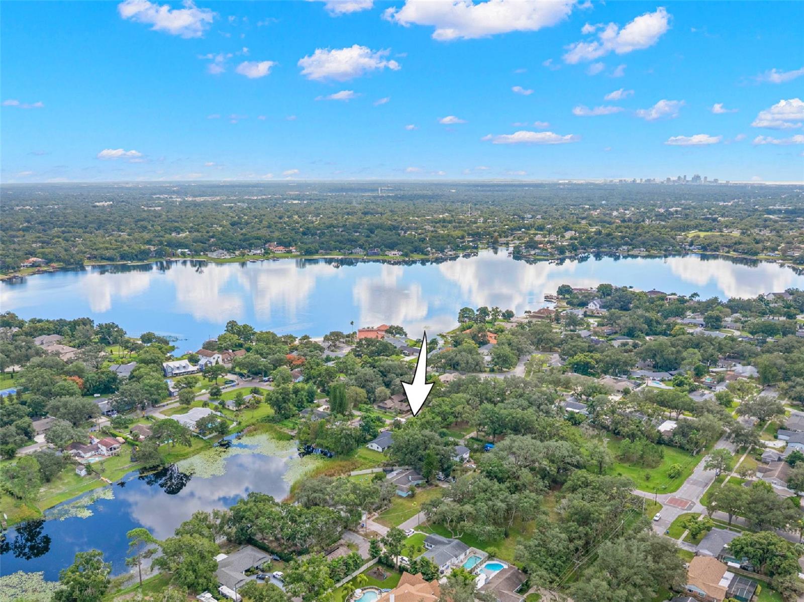 Discover the charm of Carrollwood from above! This aerial perspective highlights the property's location in an established, tree-lined neighborhood, surrounded by scenic lakes and residential streets, with convenient access to North Dale Mabry Highway and the greater Tampa area.
