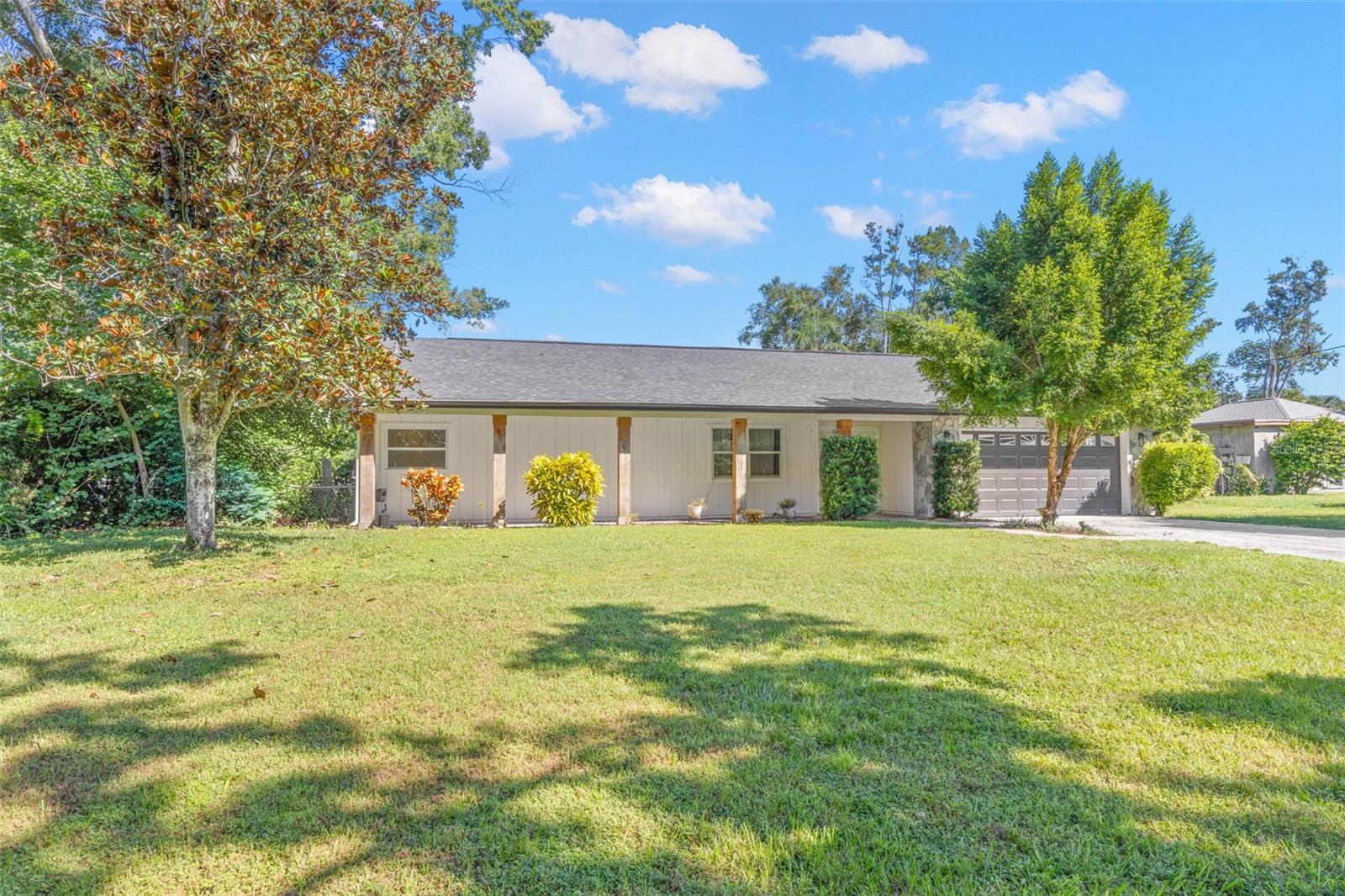 Set on a spacious .34-acre lot, this attractive single-story home features a sweeping front lawn, mature shade trees, established landscaping, and a welcoming covered front porch.