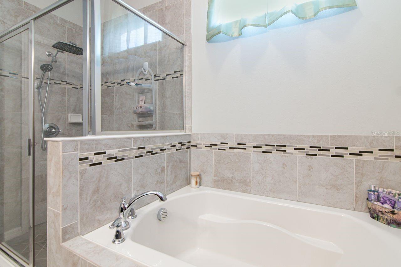 Separate soaking tub and walk in shower. Toilet has own room.