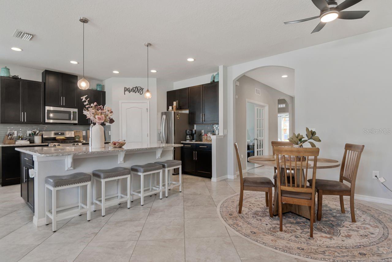Open concept kitchen with plenty of counter seating availability, large countertop perfect for entertaining.