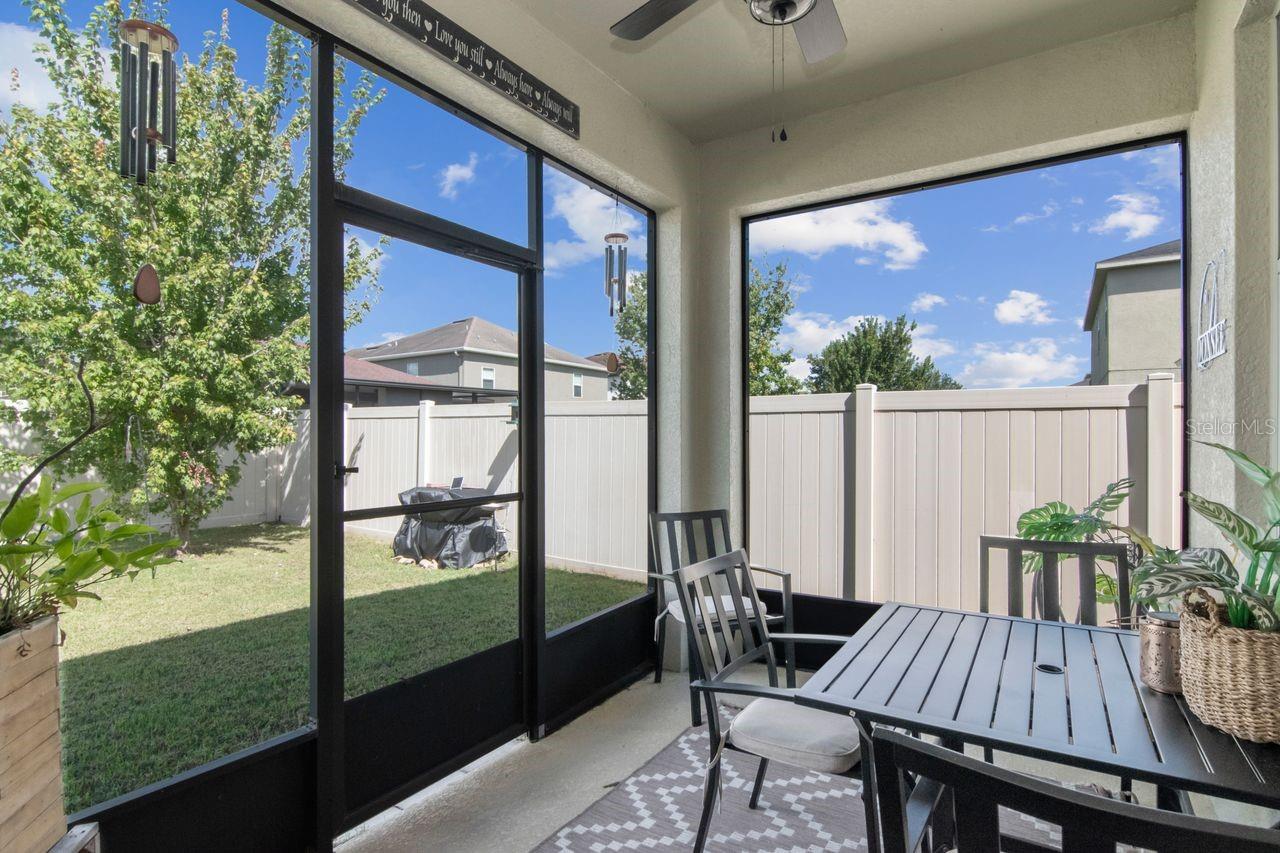 Enclosed patio with fan overhead.