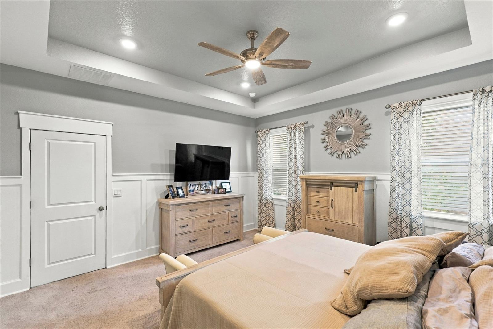 Primary Bedroom Featuring Tray Ceiling and Generous Living Space