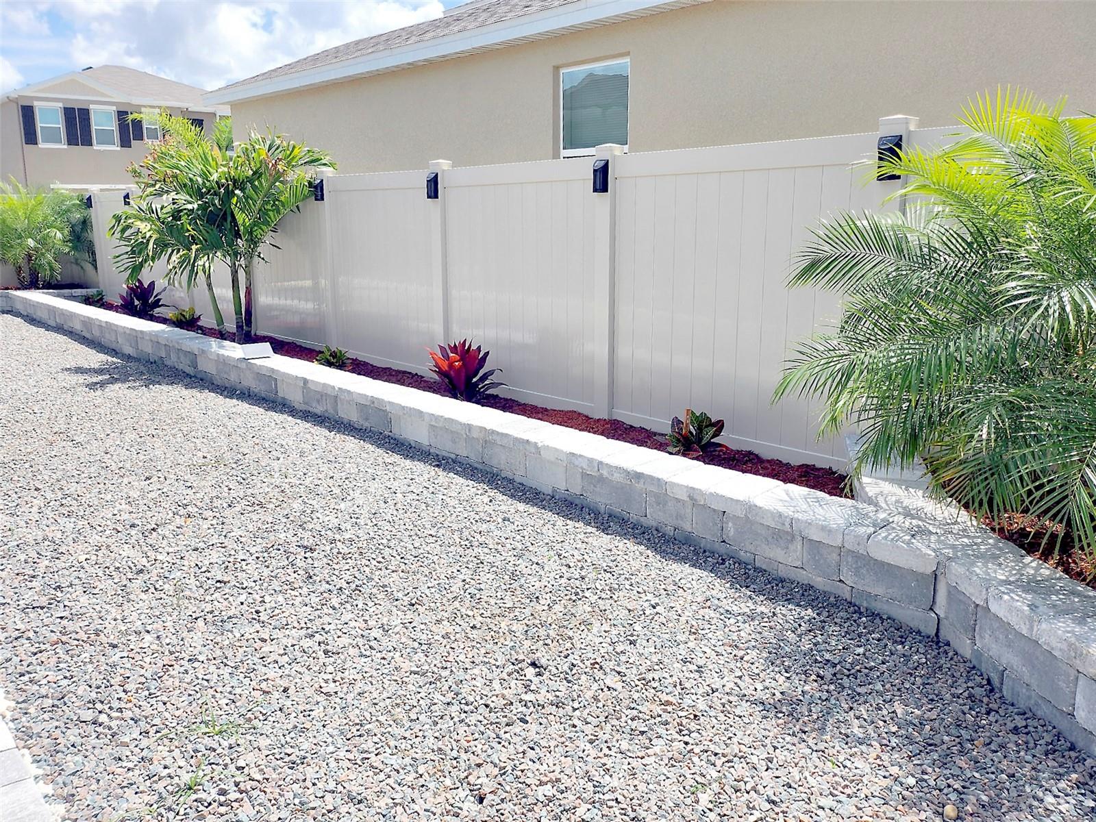 Backyard low-maintenance landscaped with decorative stone