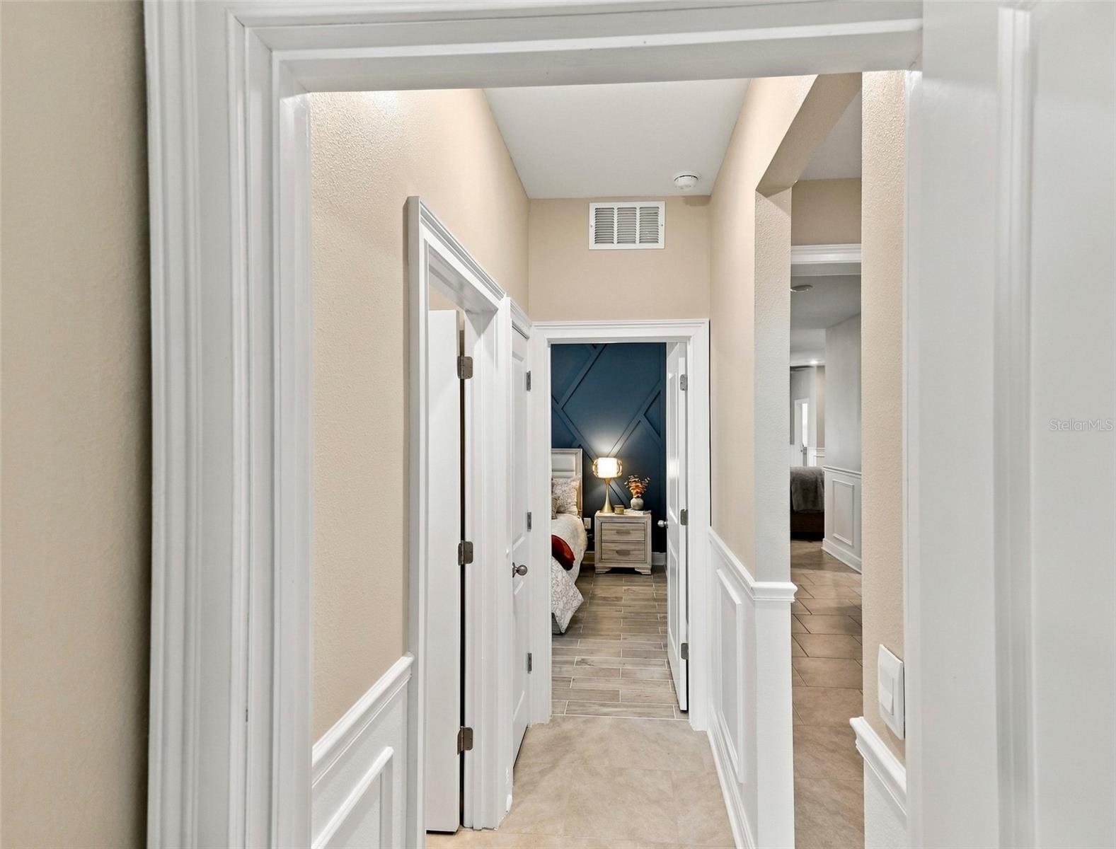 Beautiful Hallway Featuring Decorative Wall Molding and Tile Floor
