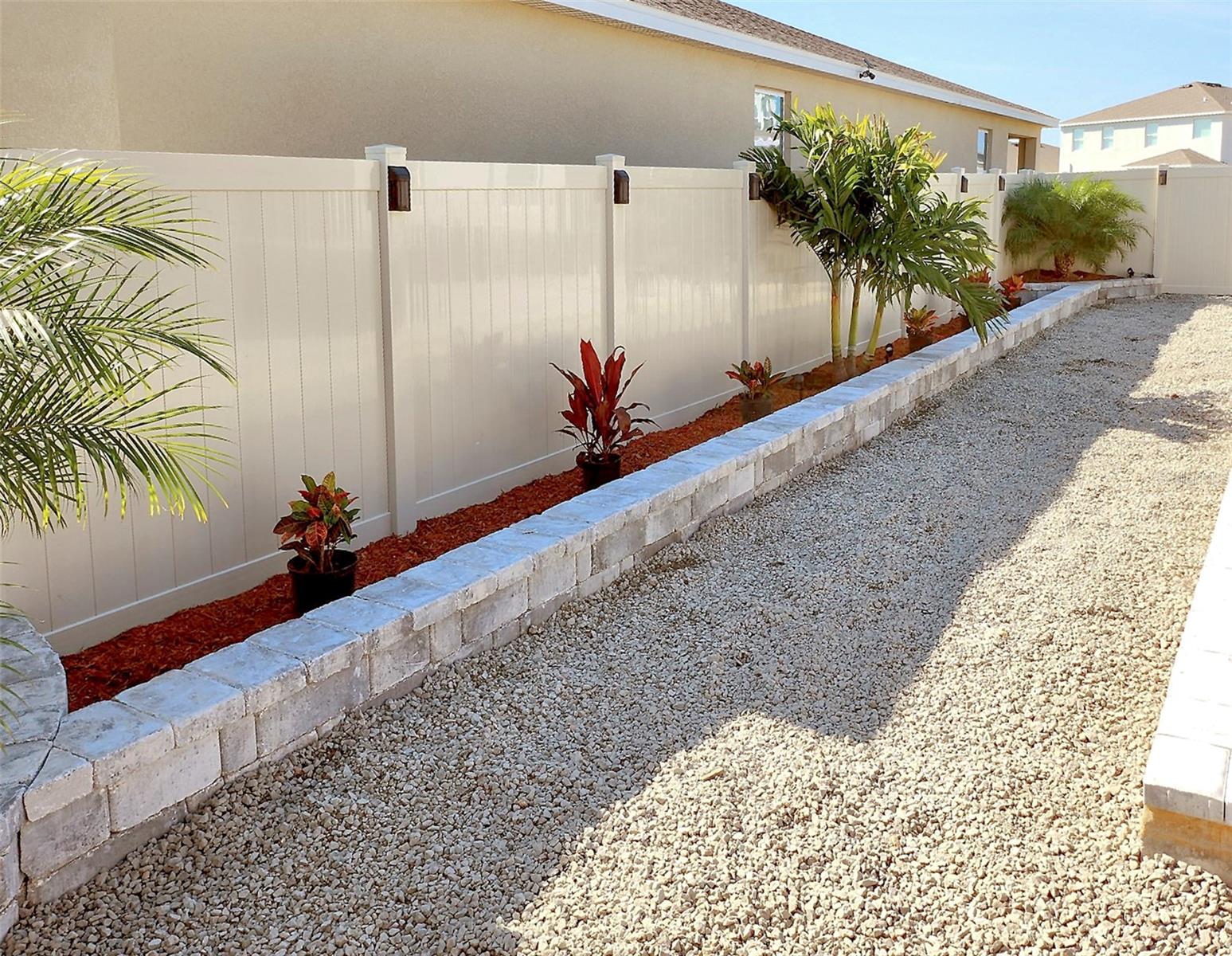 Backyard low-maintenance landscaped with decorative stone