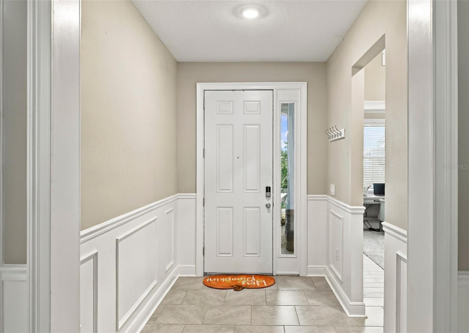 Foyer Featuring Elegant Wall Molding and Decorative trim