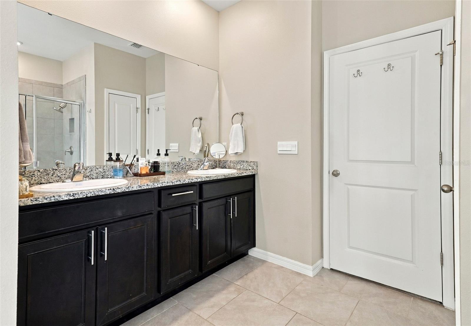 Primary Bathroom with Dual-Sink Vanity and Ample Cabinet Storage