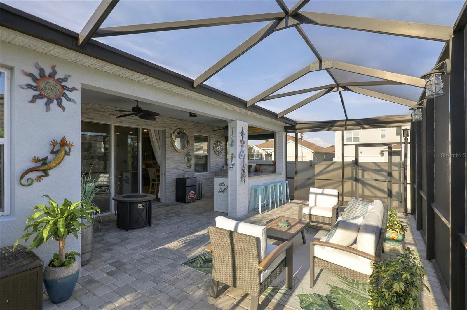Expansive Screen-Enclosed Patio with Outdoor Entertaining Space