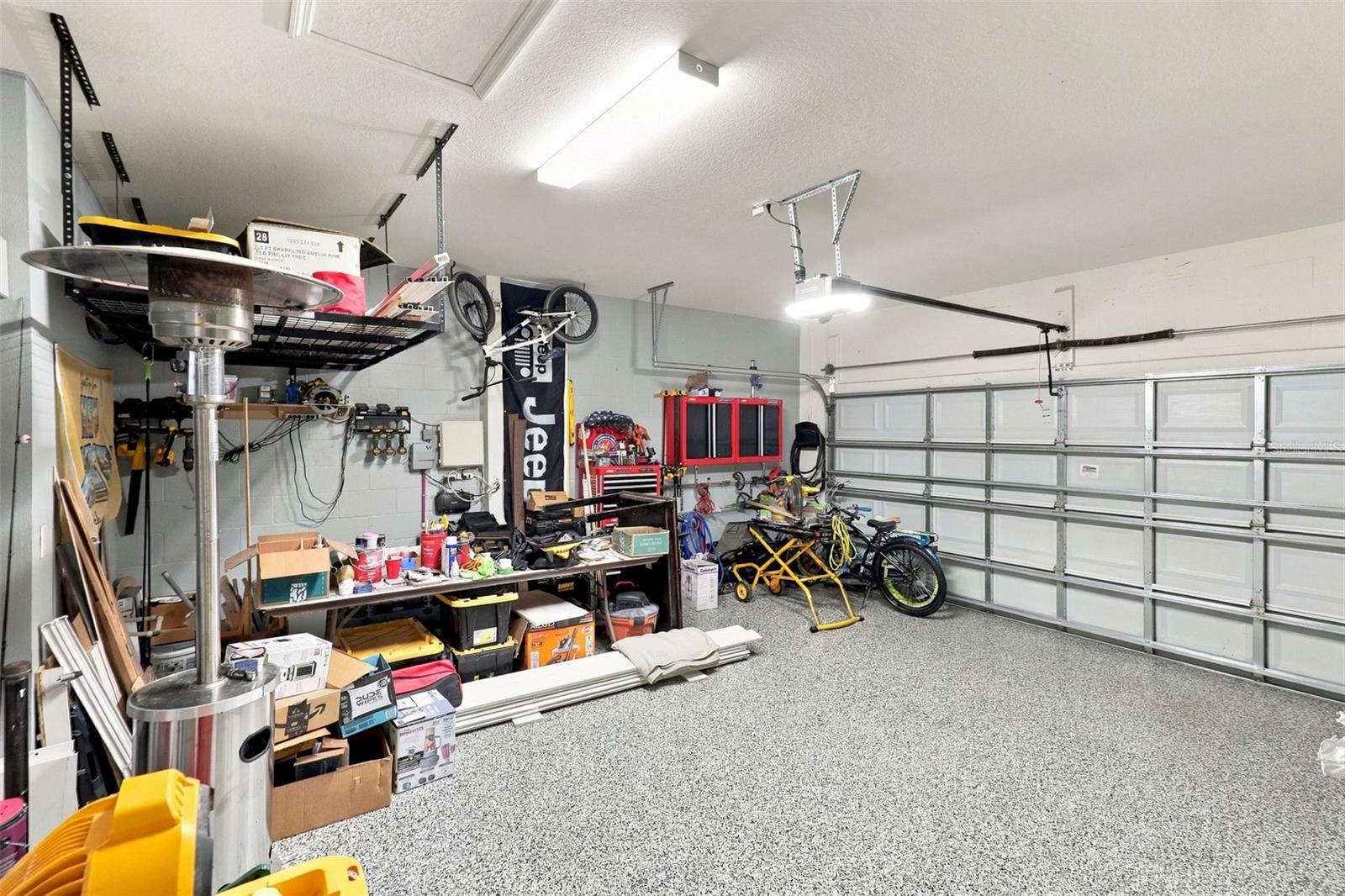 Garage Showcasing Epoxy-Coated Flooring and Ample Storage Space