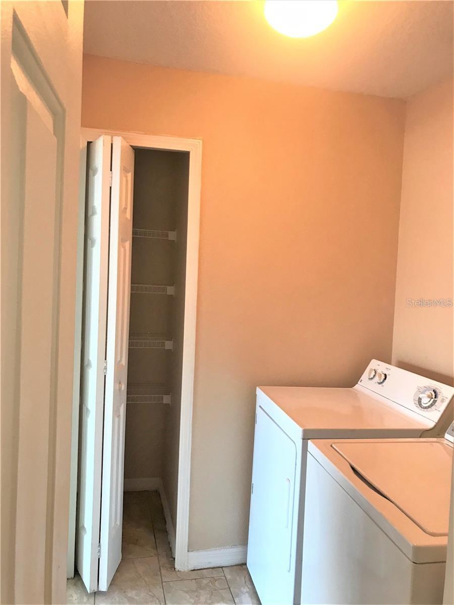 Laundry room with a closet
