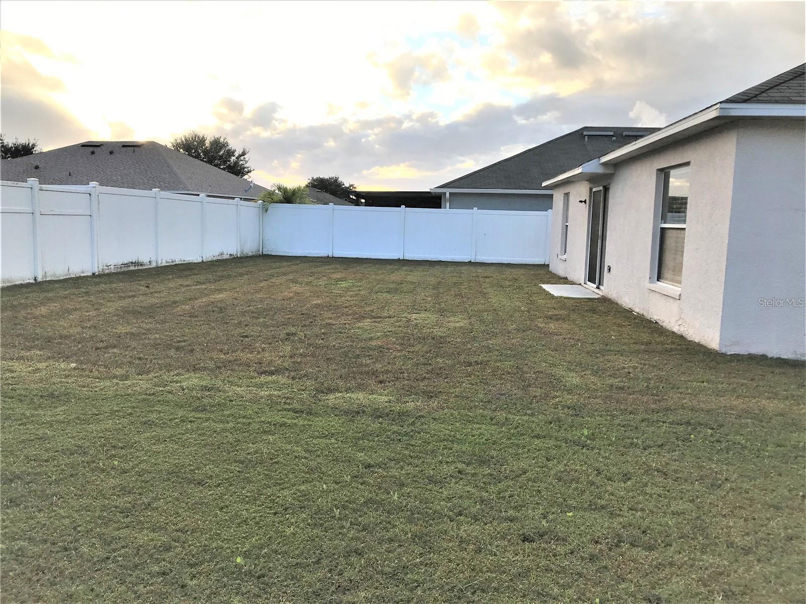 Fully Fenced Large backyard with PVC Fence installed not long ago