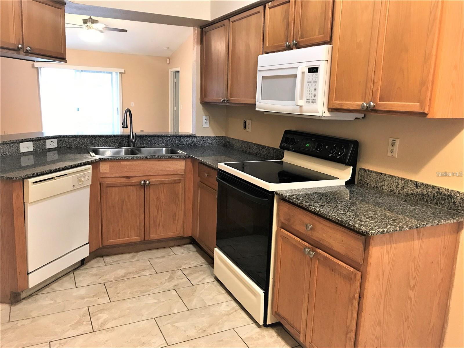 Kitchen with Granite Counter Tops and Wood Cabinets