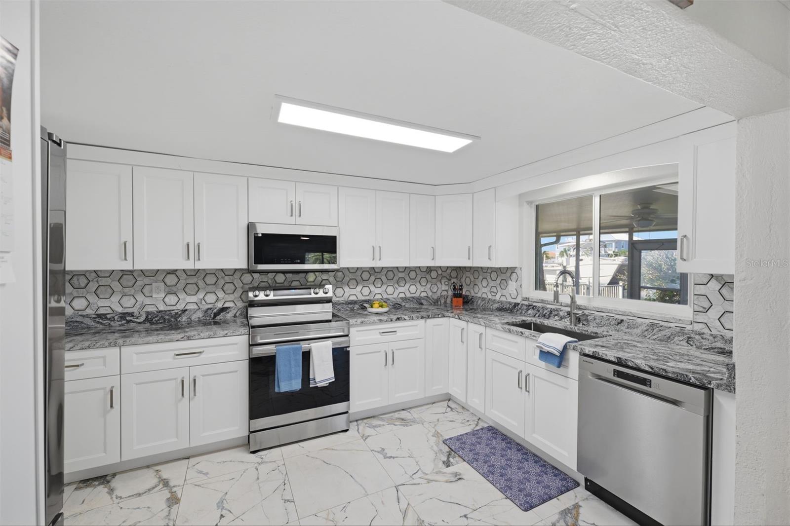 Abundant Kitchen cabinets. All new!  Water view.