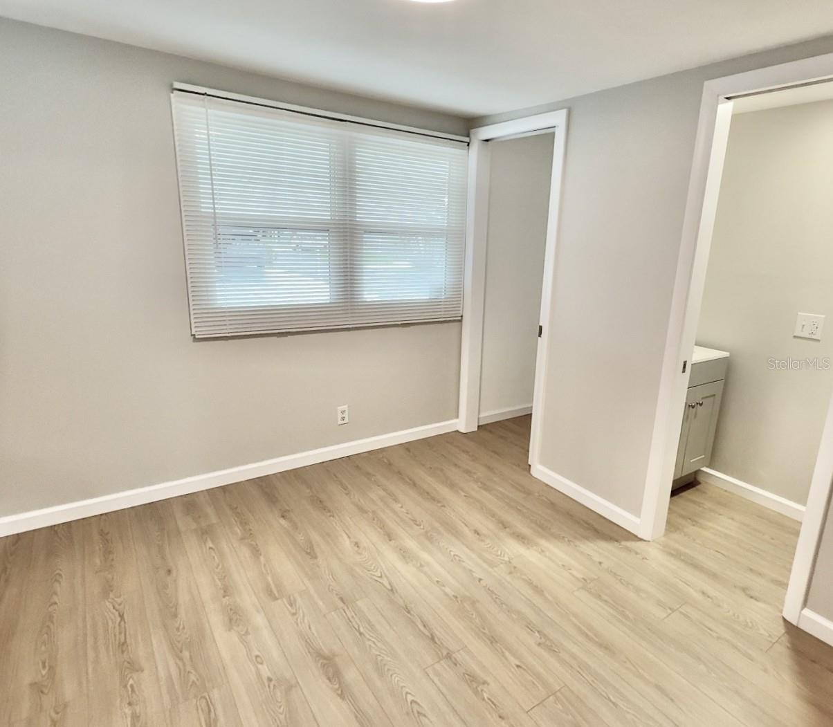 guest bedroom with ensuite half bath