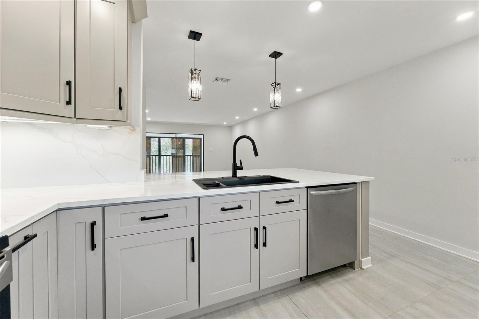 All-new LED can lighting with stylish pendant lights over the kitchen bar