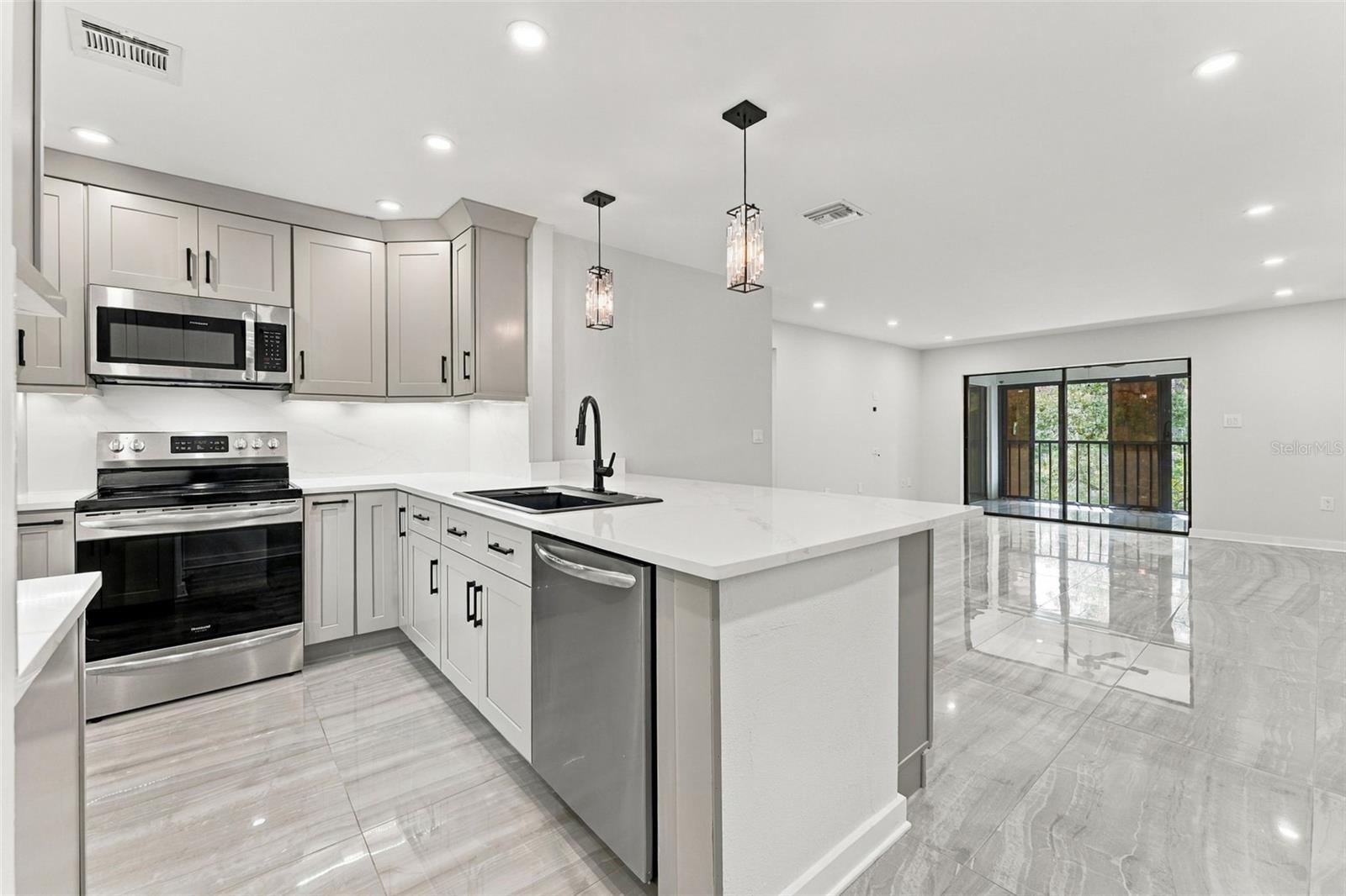 Beautiful kitchen featuring quartz countertops and matching backsplash