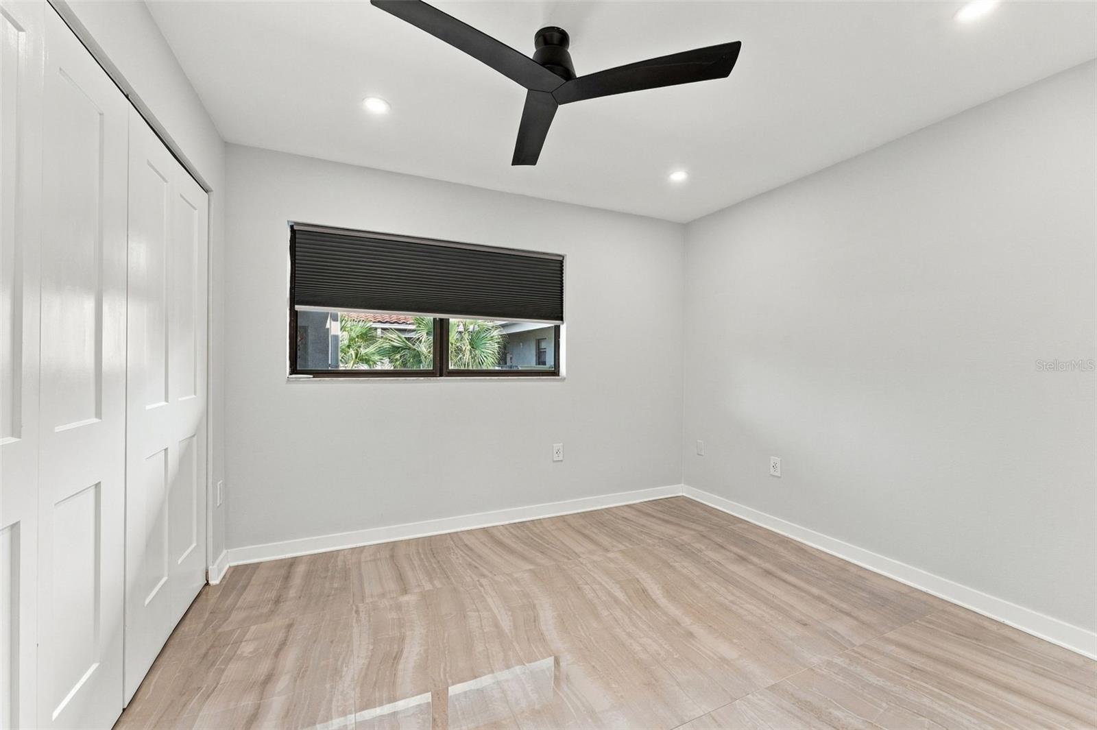 Bedroom two with new flooring, lighting and ceiling fan