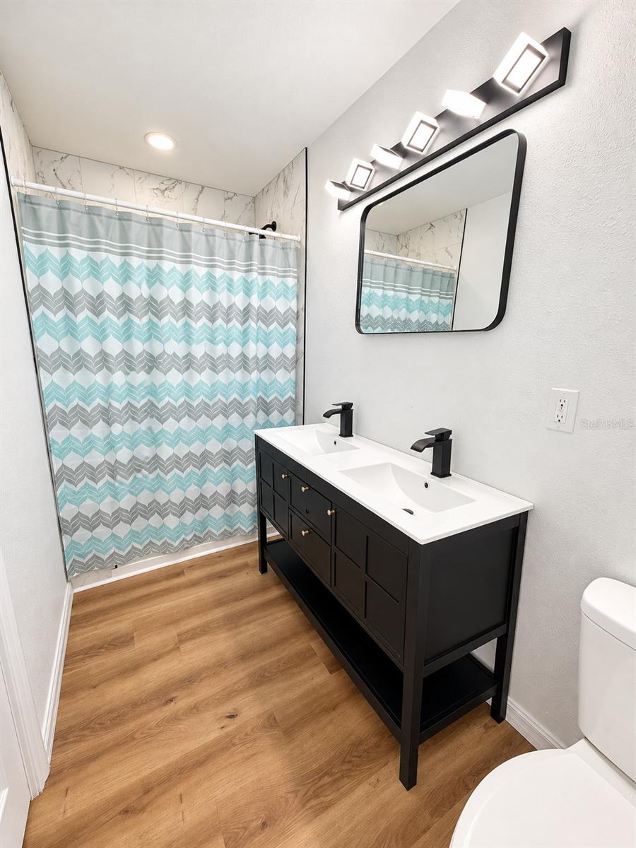 Primary bathroom with standup shower, dual vanities