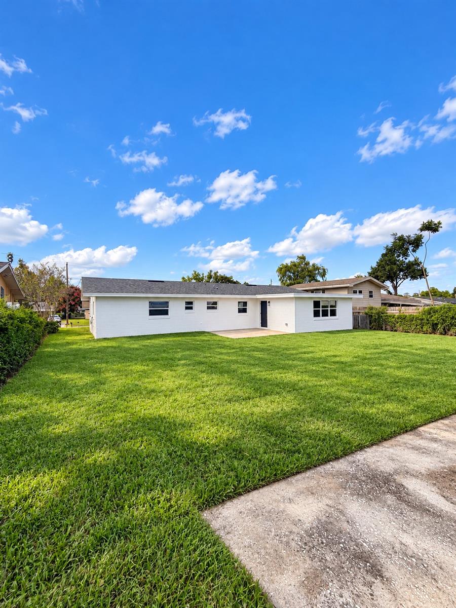 Spacious backyard offering an open lawn and room for outdoor activities.