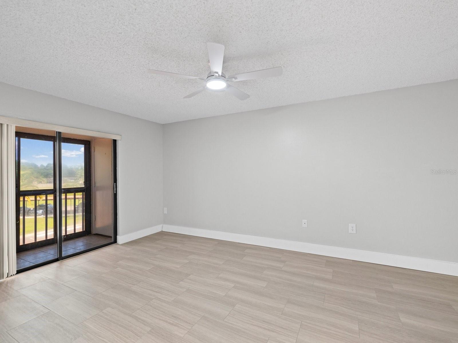 Primary bedroom with private screen patio and storage closet