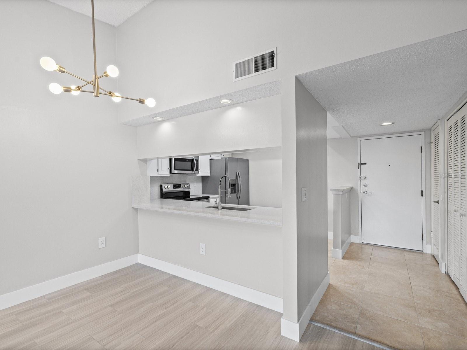 Vault ceiling and new modern light fixture in dining room