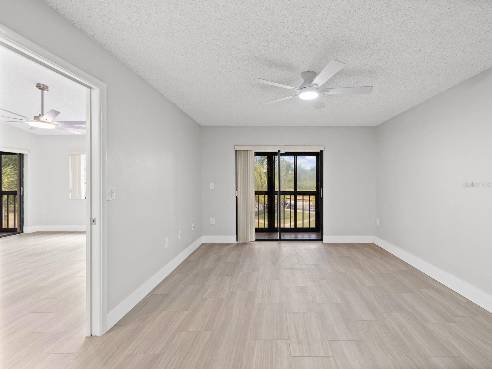 Primary bedroom is split plan on opposite side from guest room with pocket door and private patio