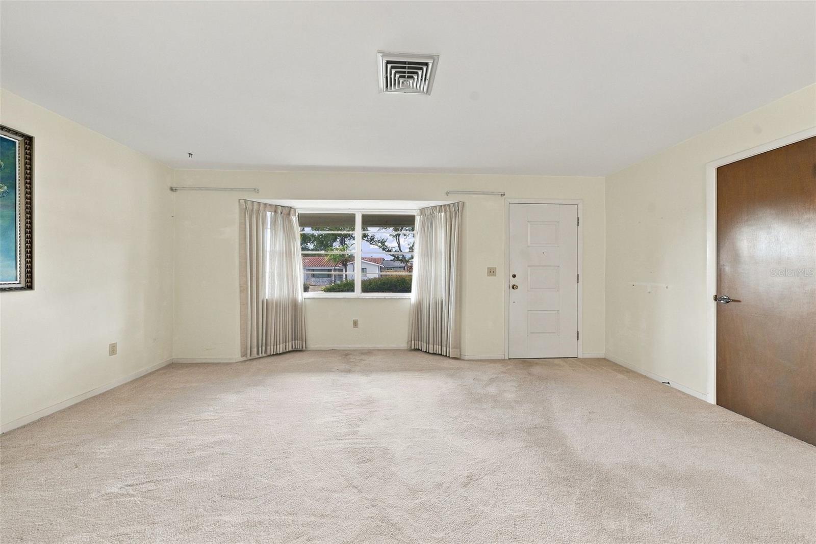 Alternate view of living room featuring large windows, lots of natural light Alternate view of living room featuring large windows, lots of natural light